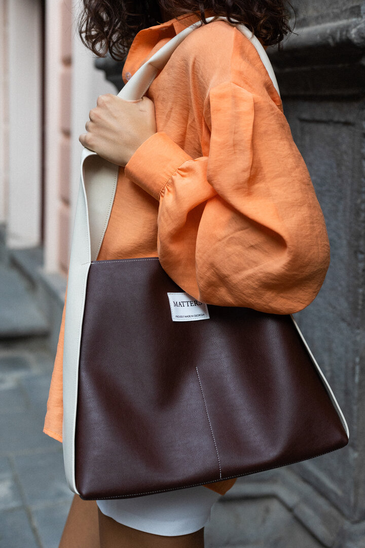 Brown eco leather bag with a white handle