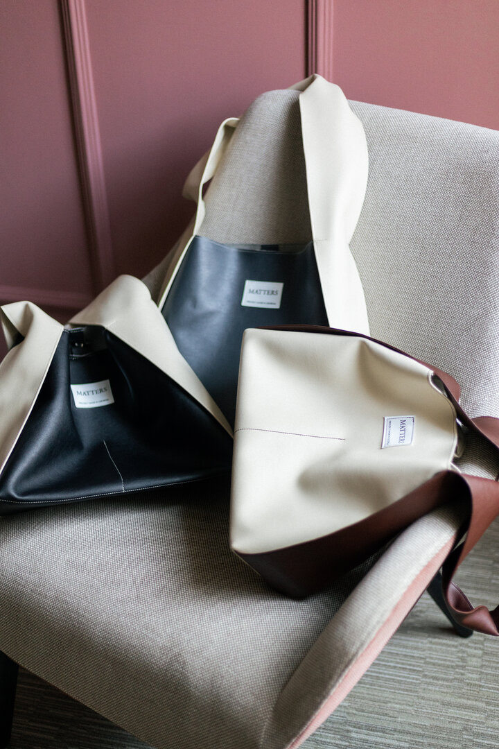 White eco leather bag with a brown handle